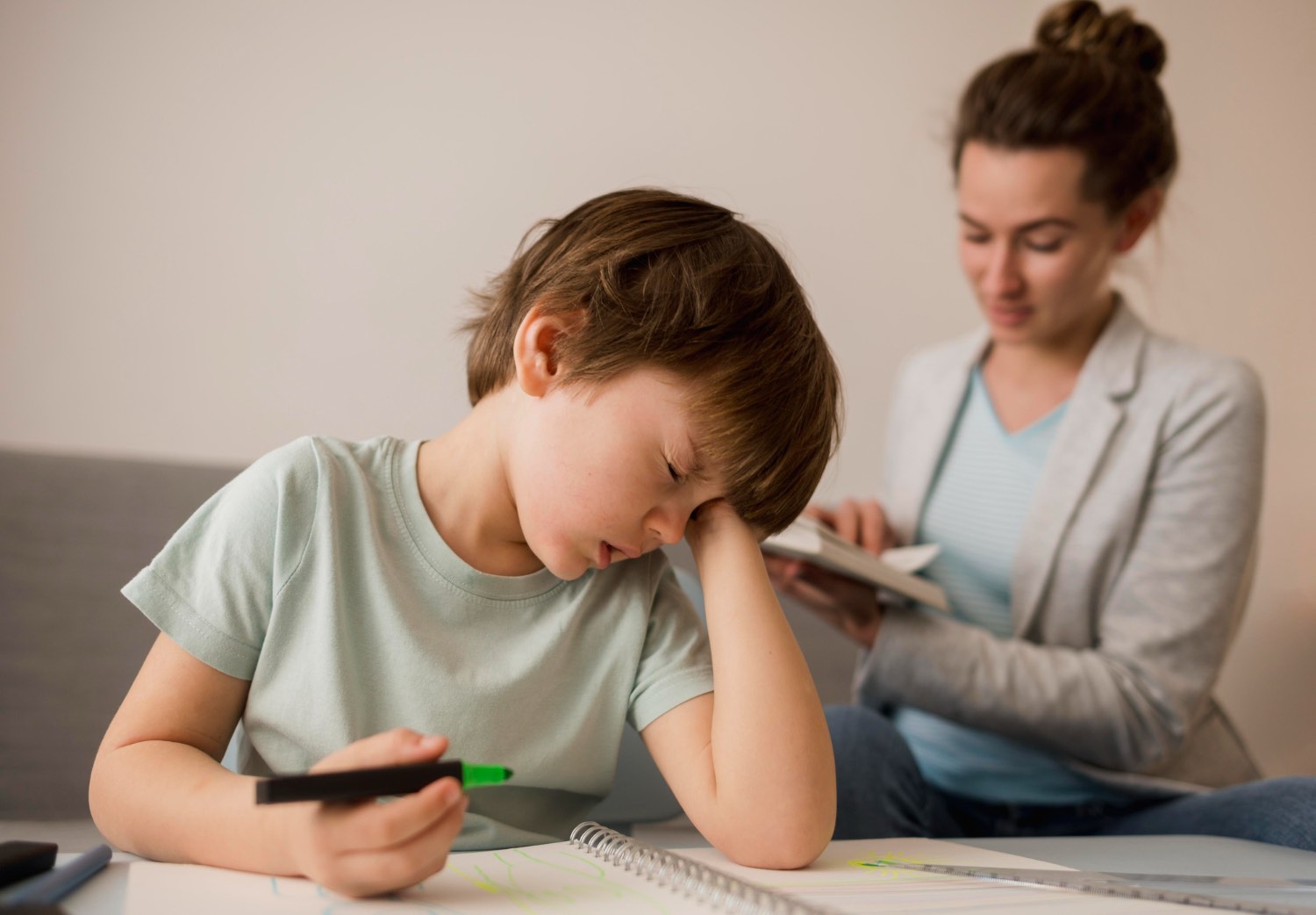 Anxiety vs ADHD Sunshine Coast children: young boy struggling with concentration and attention difficulties while parent observes, showing common signs of childhood anxiety or ADHD